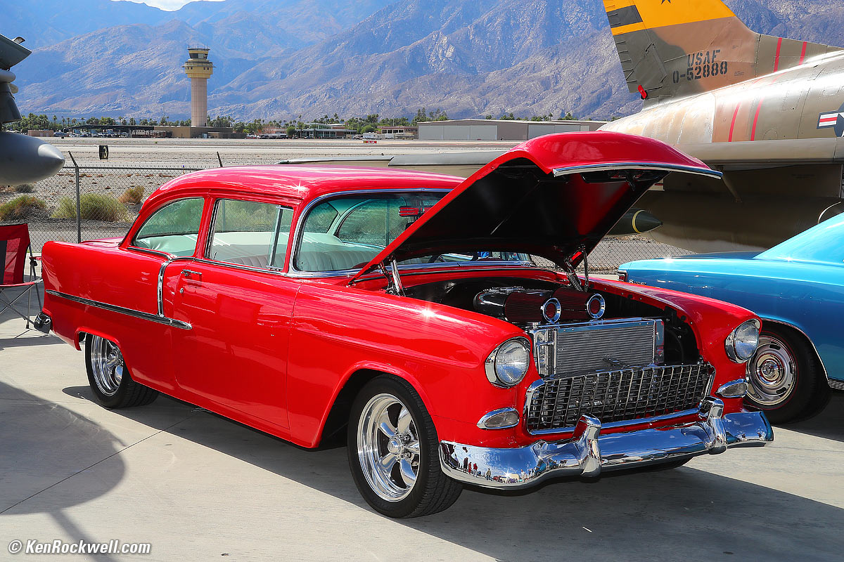 Red 1955 Chevrolet with raised hood