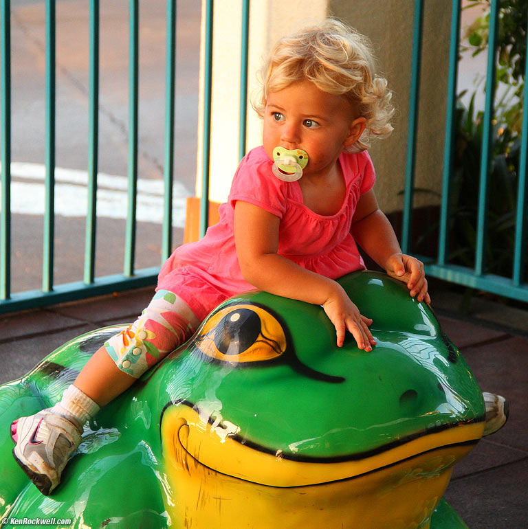Katie rides the frog at McDonald's. 