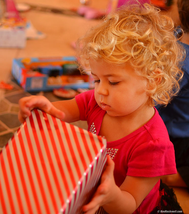 Katie contemplates how to open the next big box. 