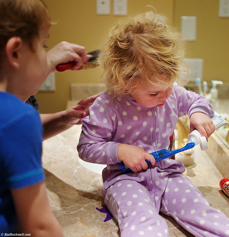 Katie brushes her teeth.