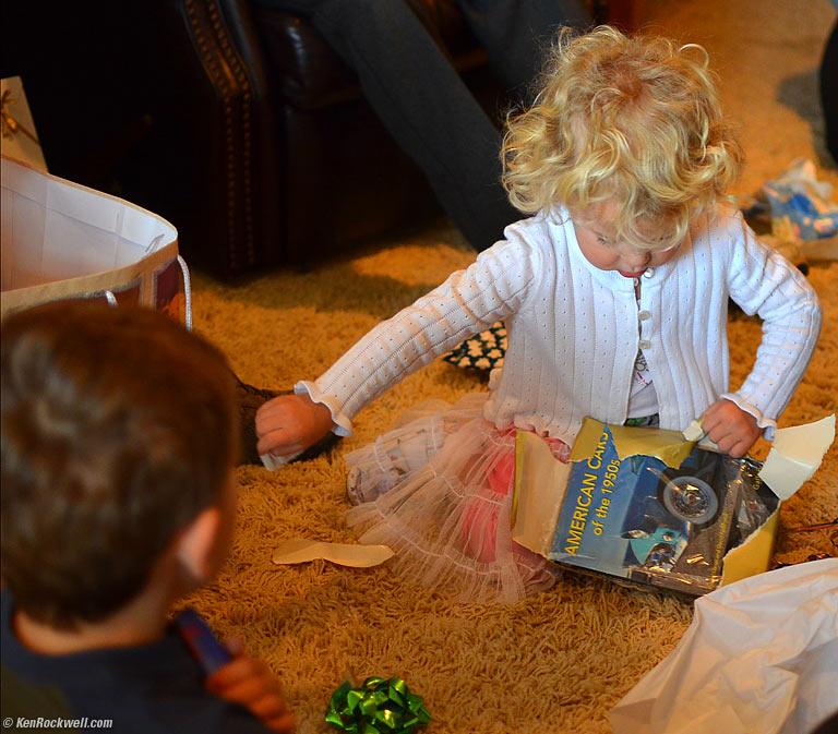 Ryan watches as Katie opens Dada's birthday present