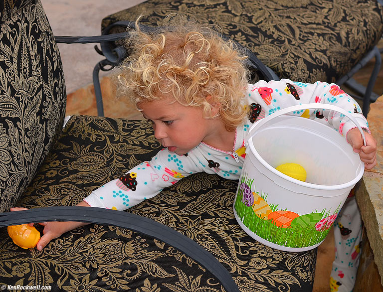 Katie collects Easter eggs from the yard