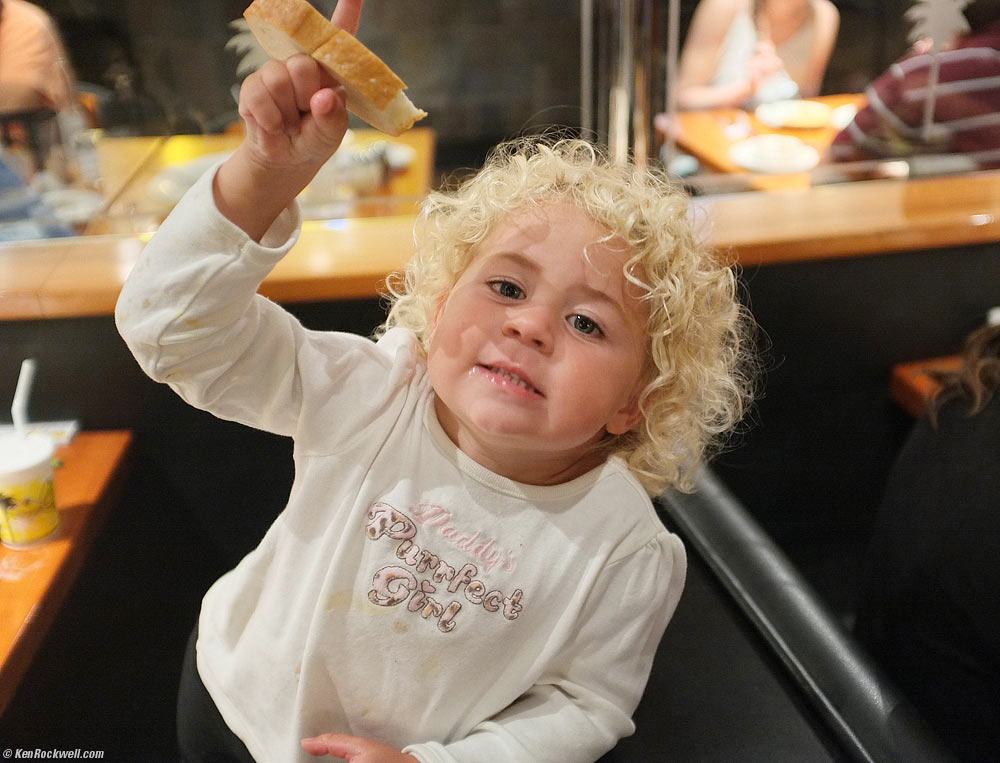 Katie puts her finger through a hole in a piece of bread