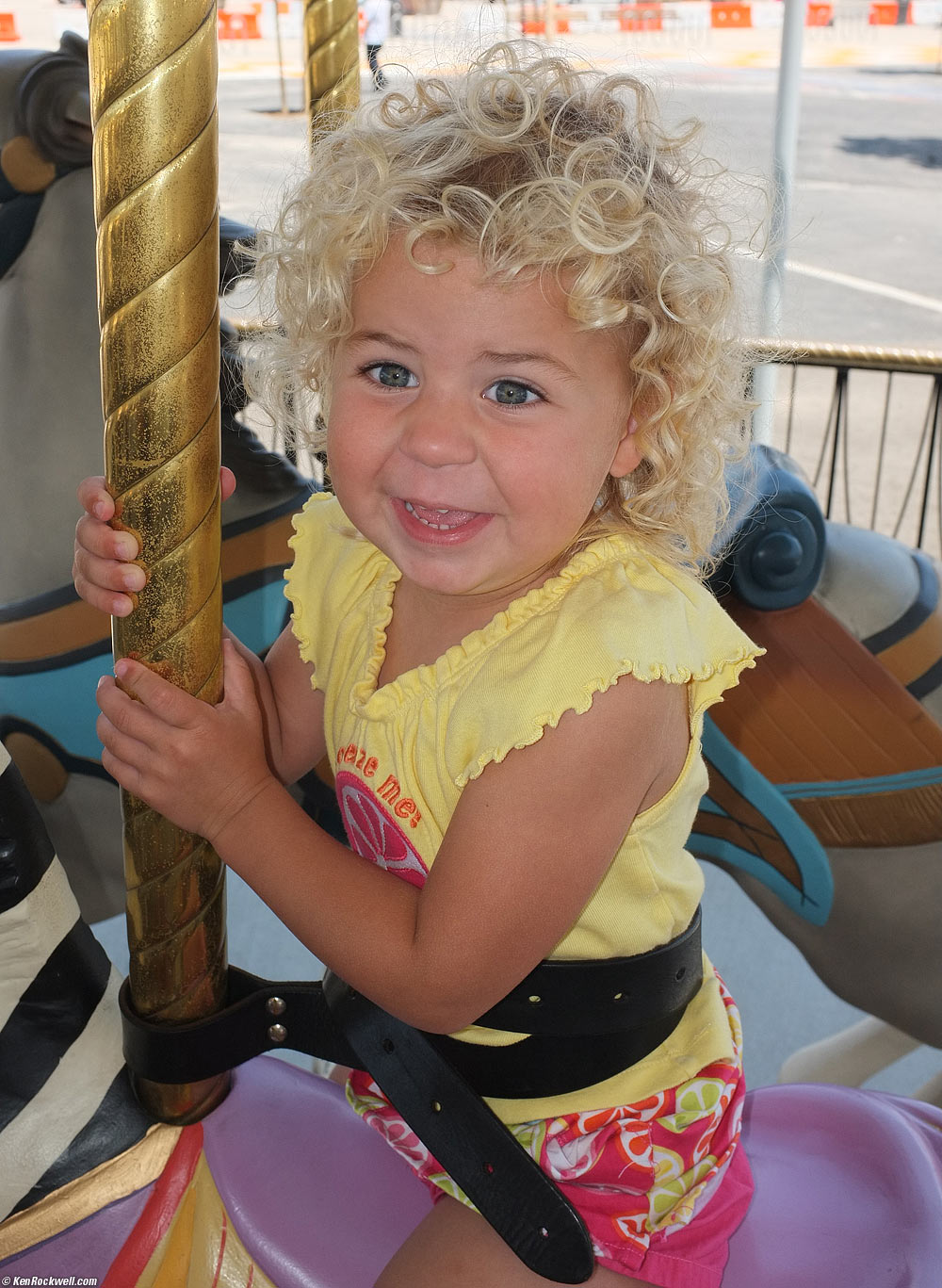 Katie rides the Merry Go Round.