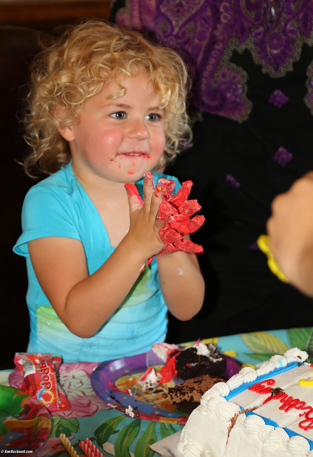 Katie plays with the red icing
