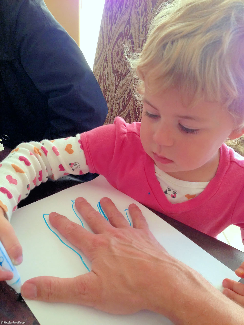 Katie traces Dada's hand