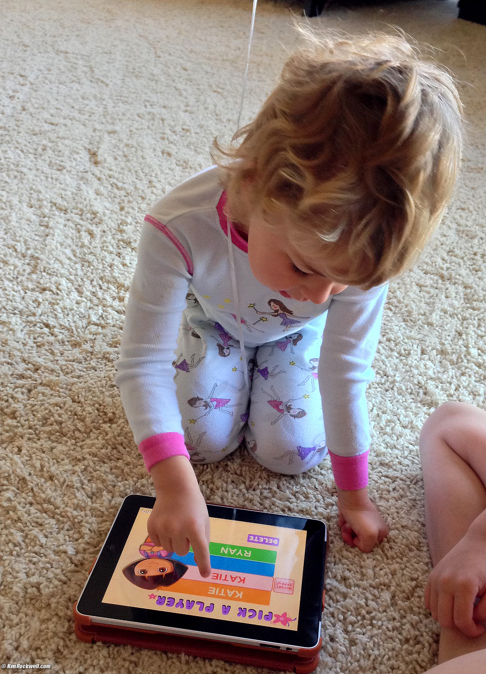 Katie plays on the iPad. 