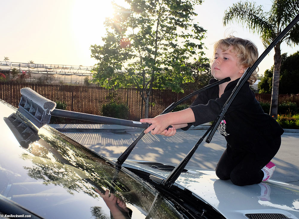 Katie washes Stomper's windshield.
