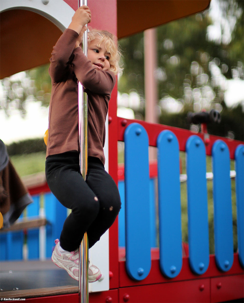 Katie slides down the pole