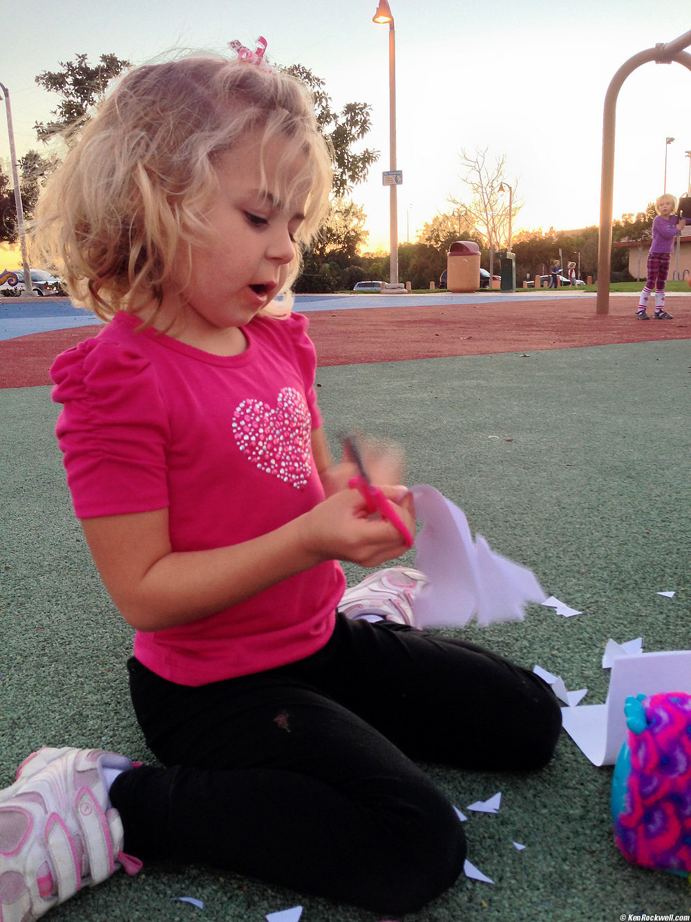 Katie cuts out snowflakes at the park