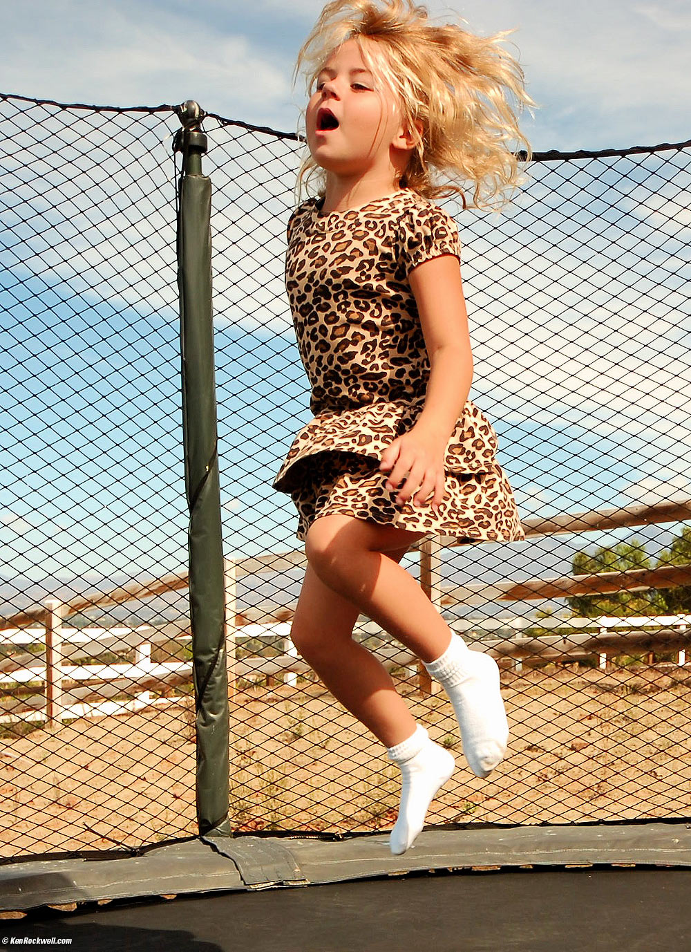 Katie jumps on Ryan's birthday trampoline.