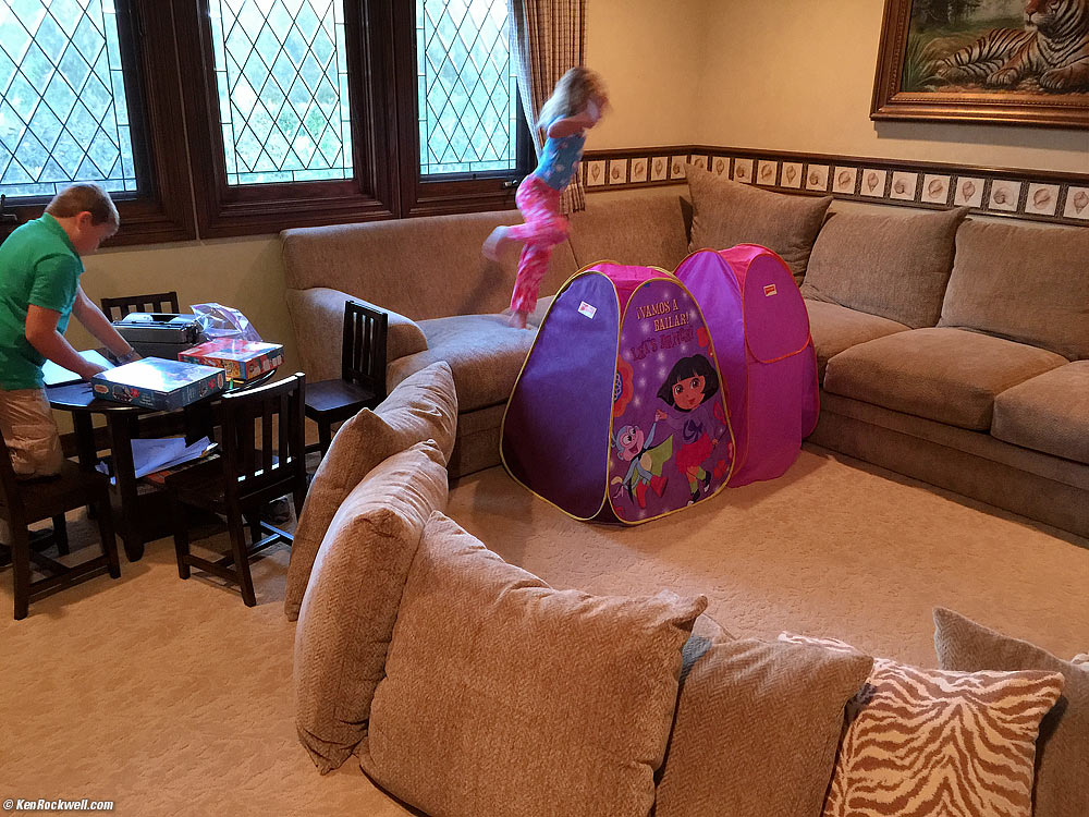 Ryan tries to concentrate while Katie bounces around her fort.