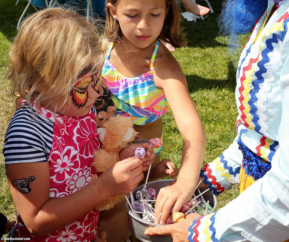 Katie checks out the lollipops and her new bear.