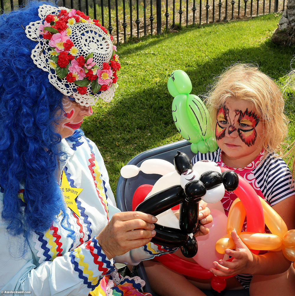 Katie cleans up with a balloon parrot, balloon panda and balloon bear holding a heart.