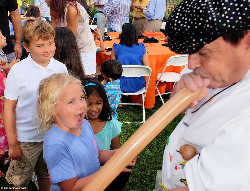 Katie likes the balloon animals at Neal's birthday party