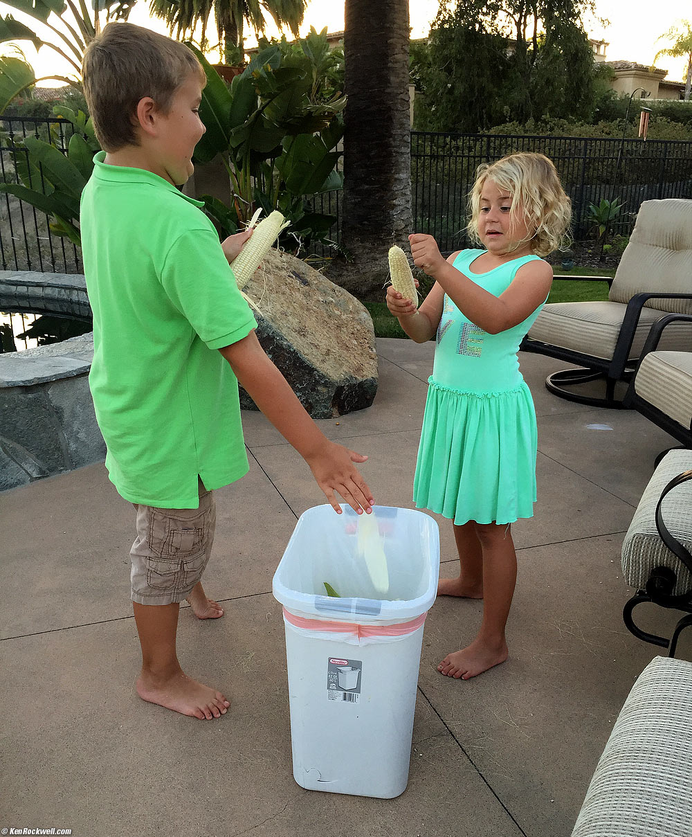 Kids shucking corn for dinner