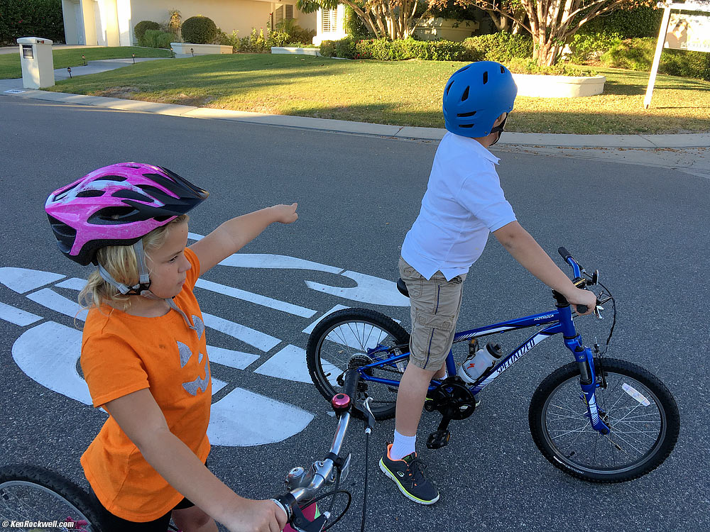 Kids riding bikes &mdash; and using hand signals to signal their turns