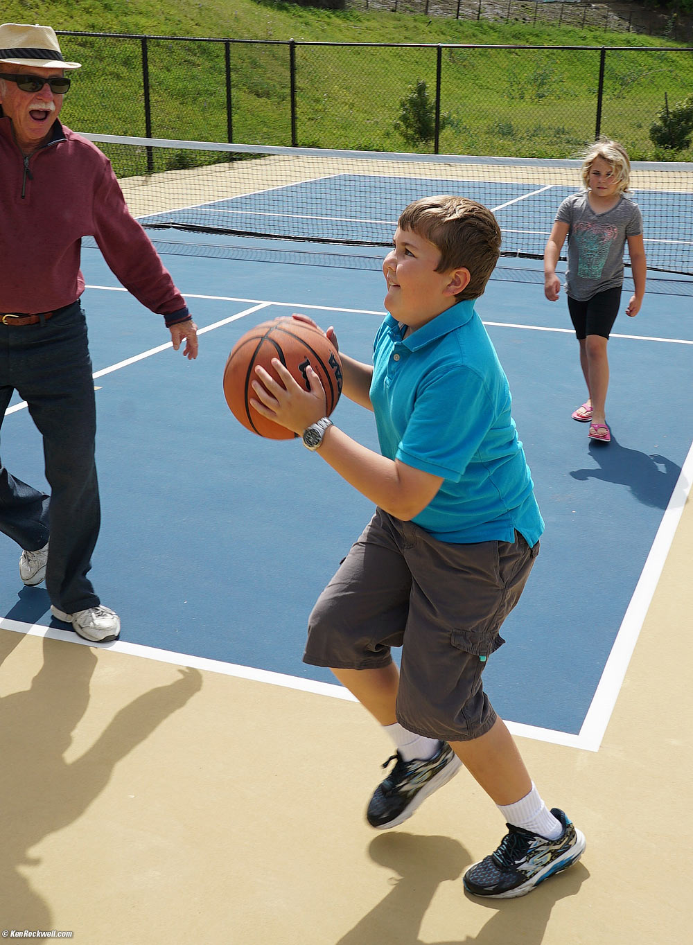 Pops, Ryan and Katie playing basketball.