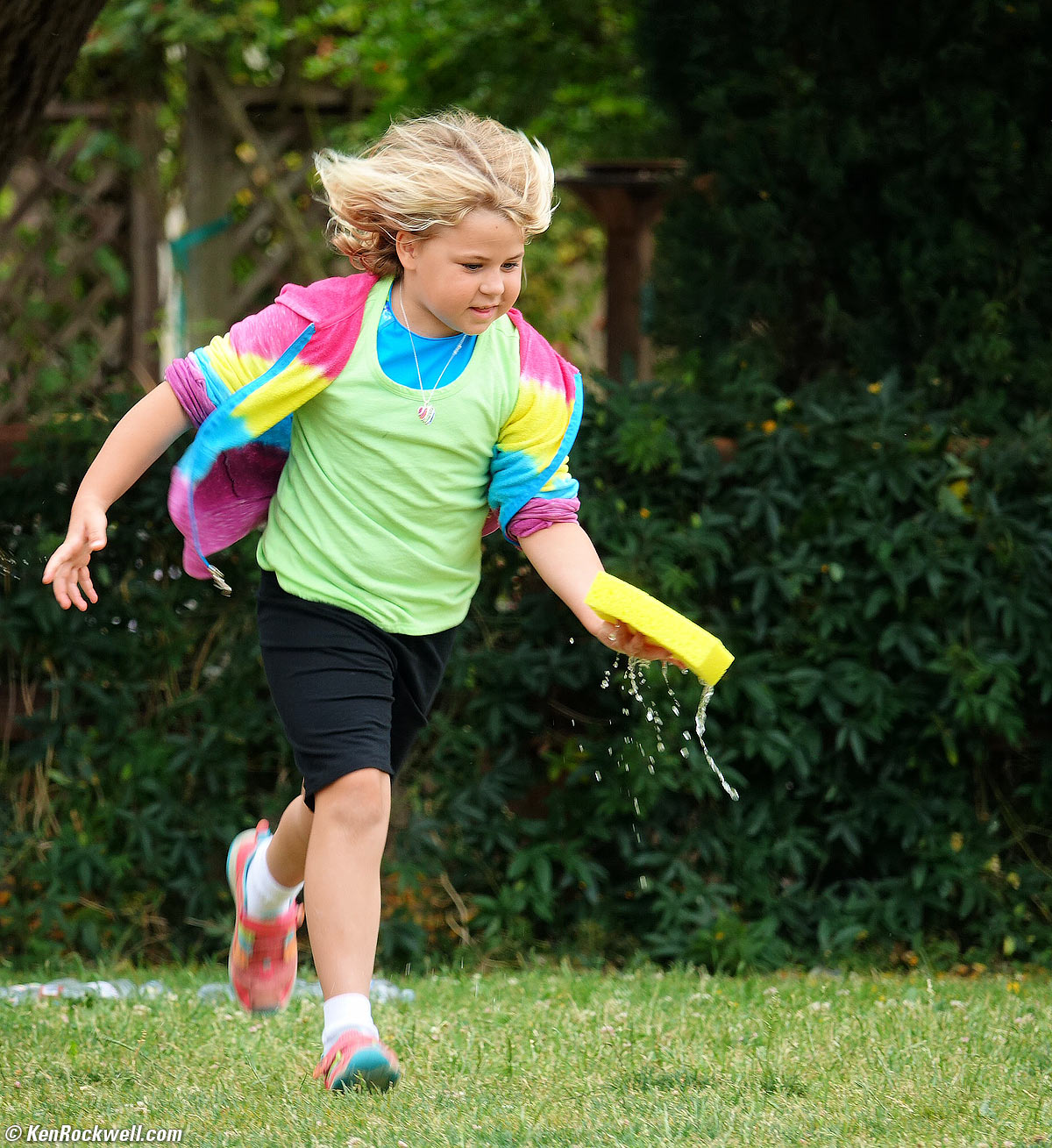Katie runs with a sponge at her second-grade field day