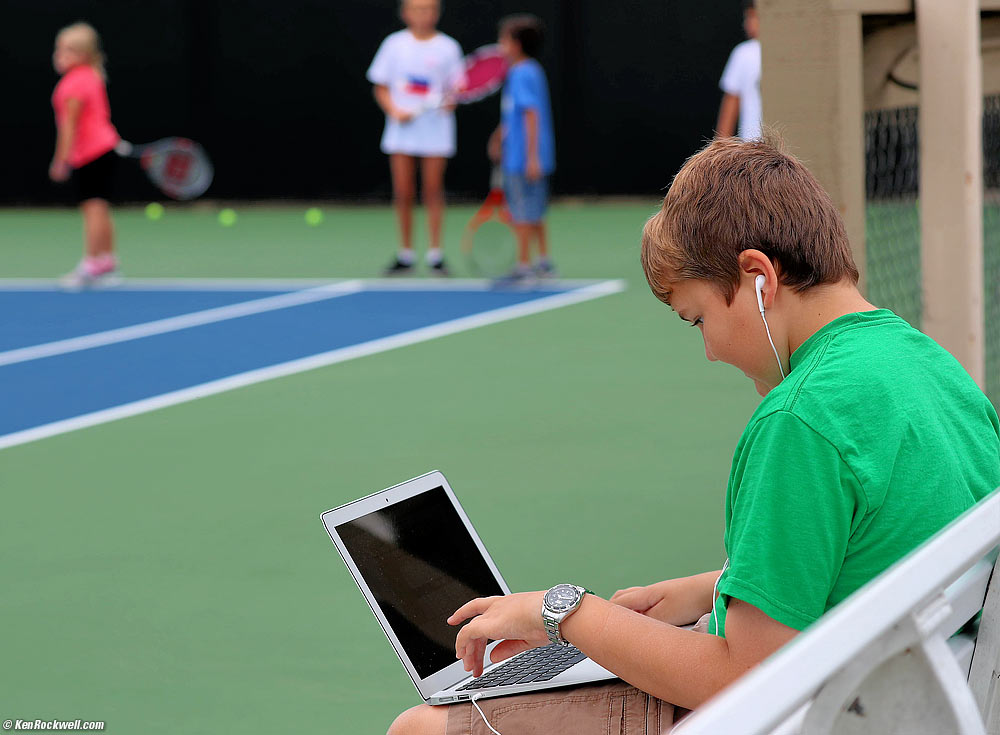 Ryan does his homework while Katie plays tennis