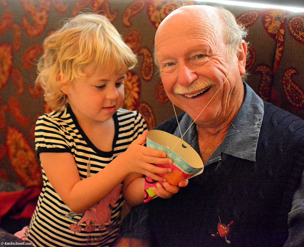 Katie puts a birthday hat on Pops.