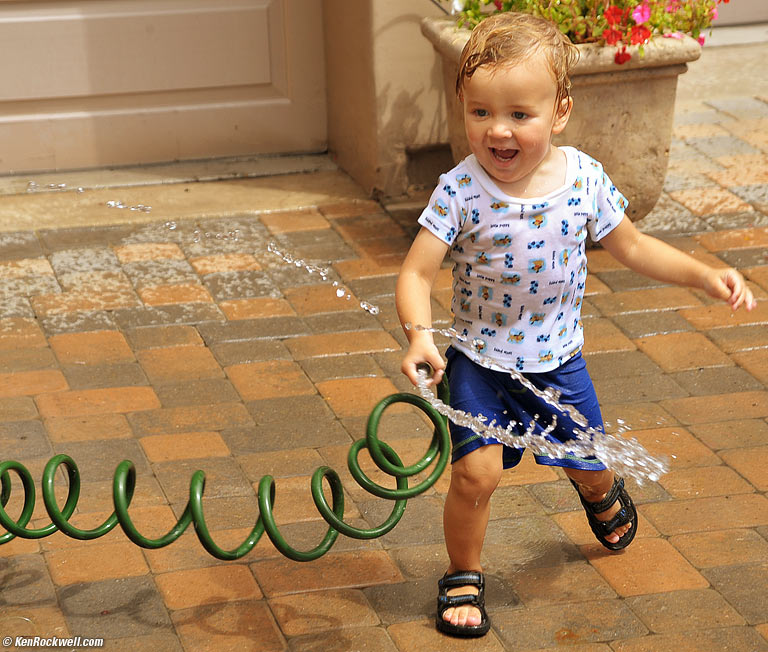 Baby Ryan playing with hose