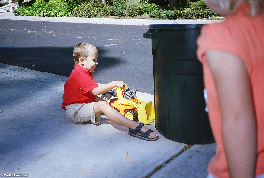 Ryan uses a truck to move the garbage can. 