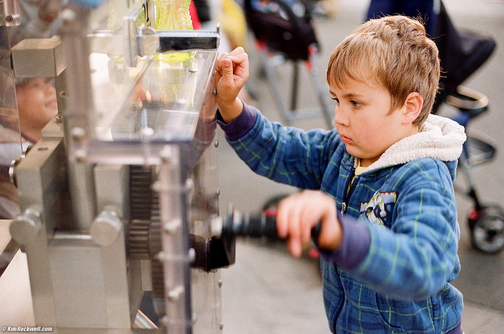 Ryan cranks the penny machine.