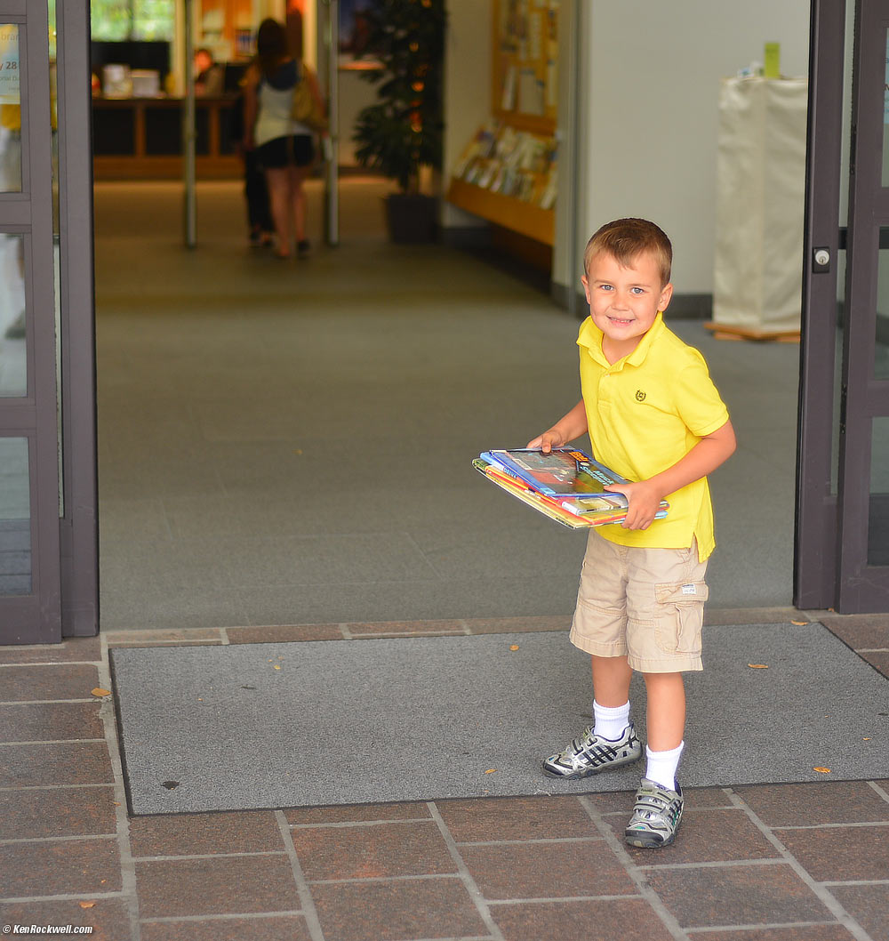 Ryan returning his first borrowed library books.