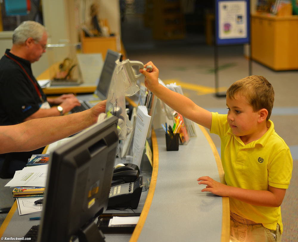 Ryan returning the headset after playing on the computers.