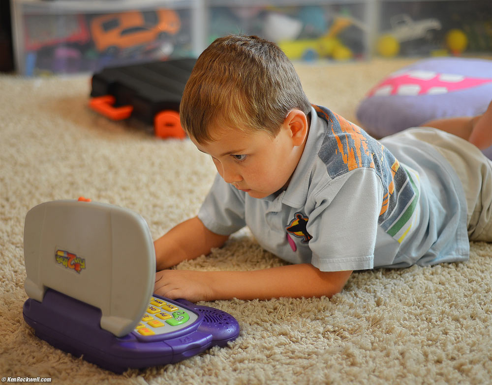Ryan with his sister's toy computer.