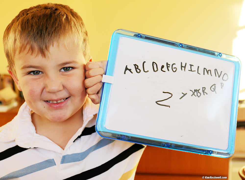 Ryan writes (most of) the alphabet.
