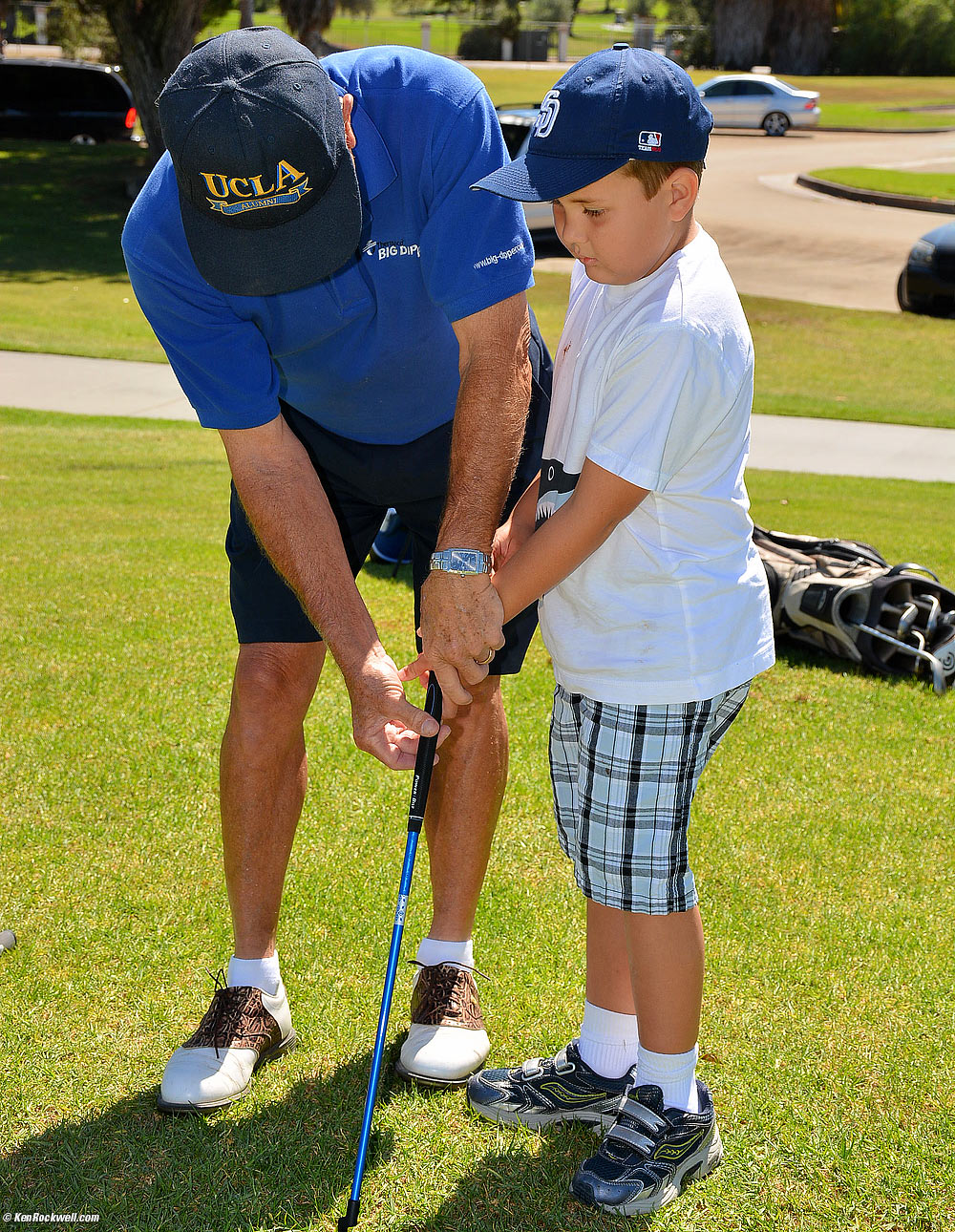 Pops shows Ryan how to hold the putter