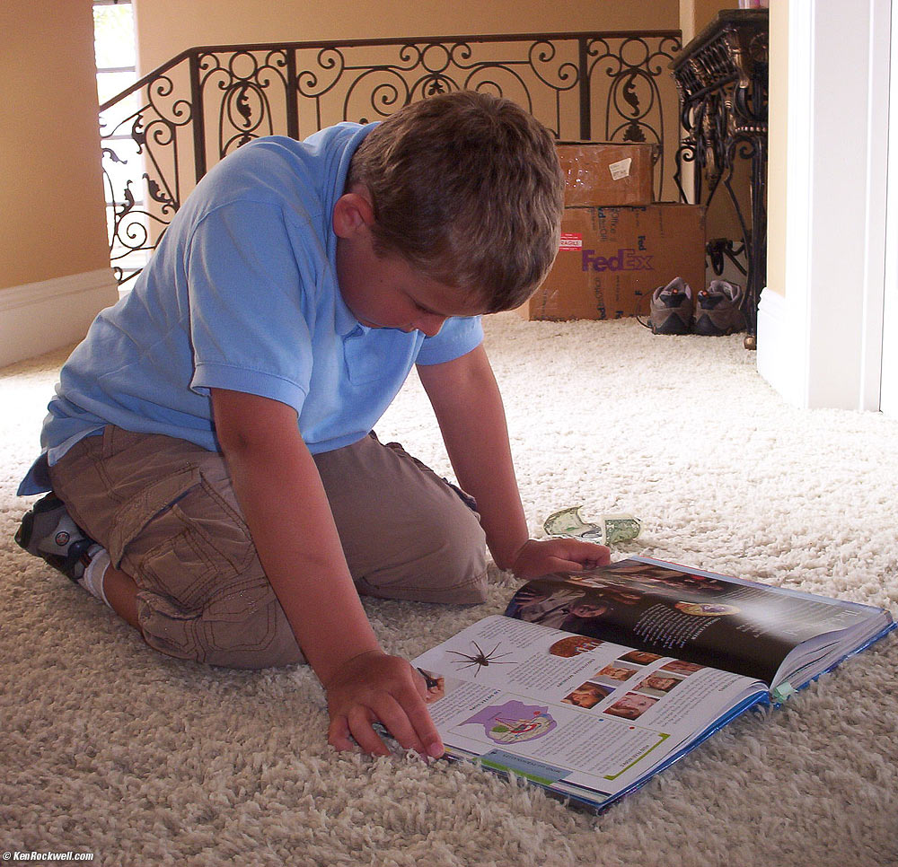 Ryan reads the book on the human body he borrowed from the library