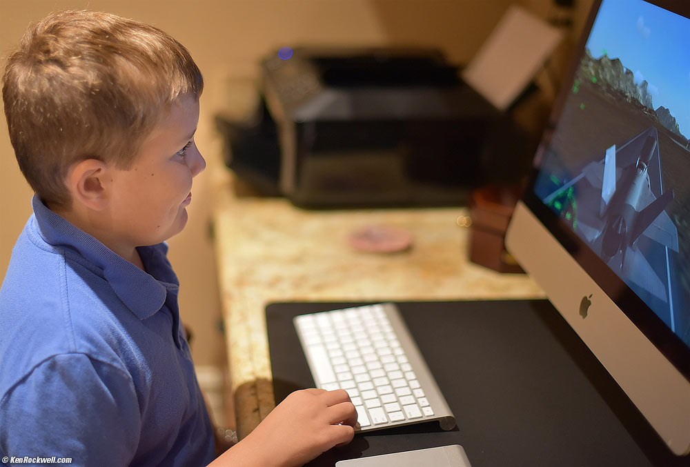 Ryan plays a flight simulator on mom's iMac