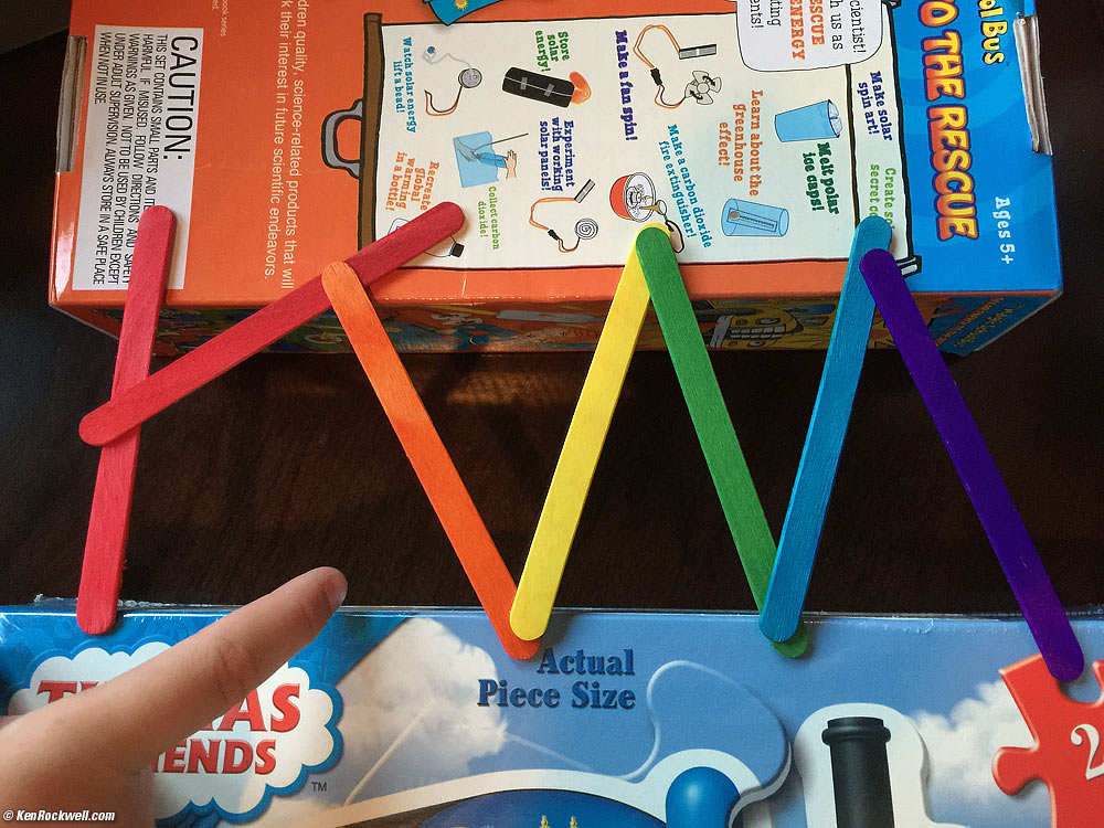 Ryan arranges popsicle sticks to fall down