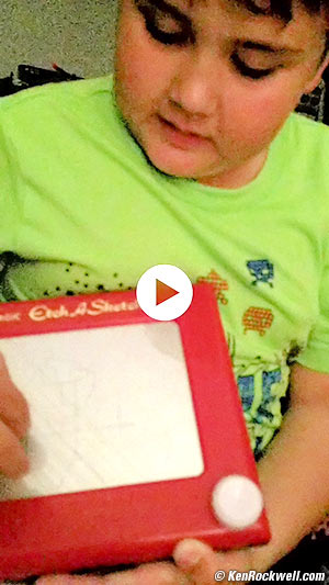 Ryan draws me on his Etch-a-Sketch