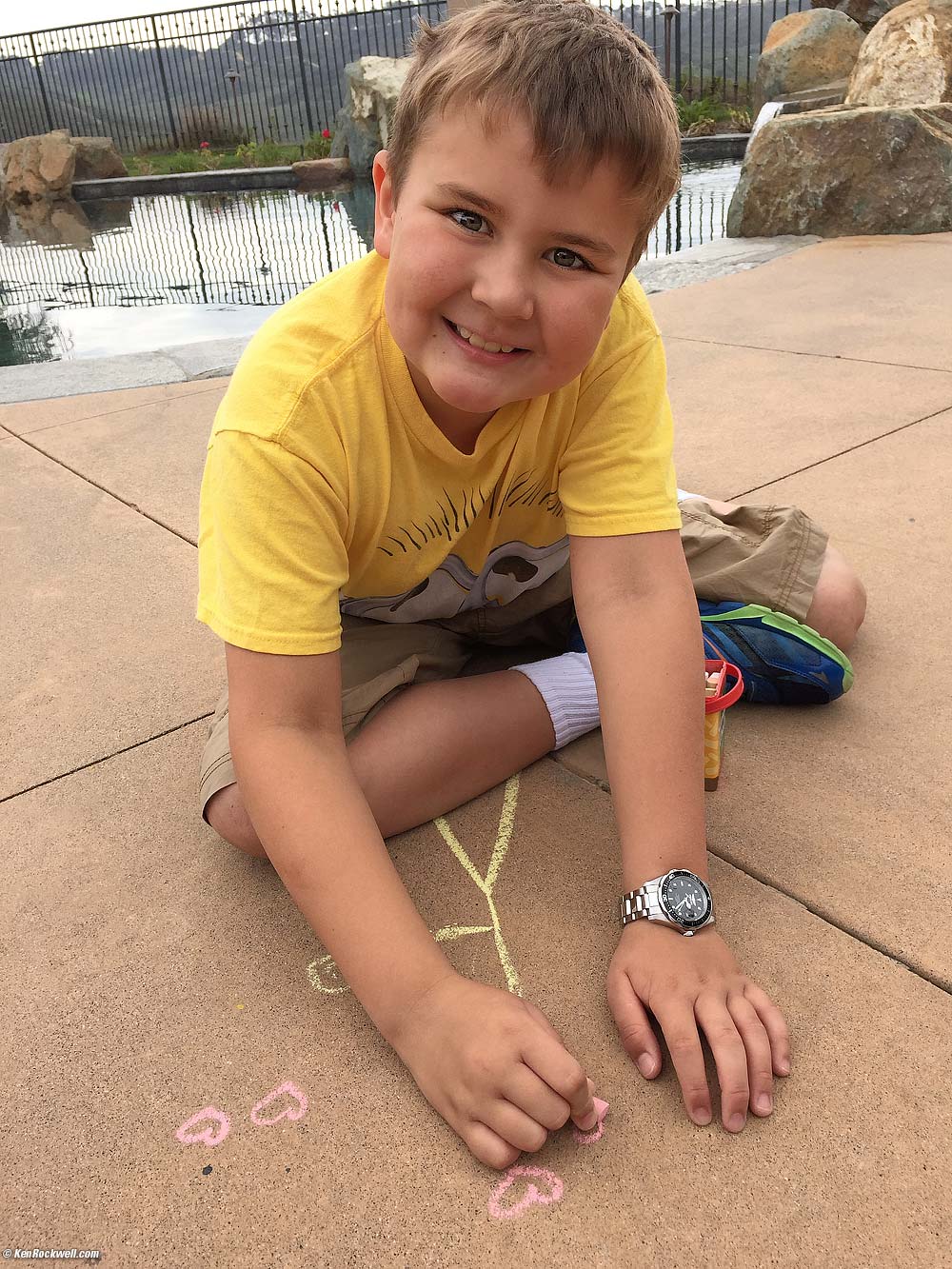 Ryan draws with chalk on concrete