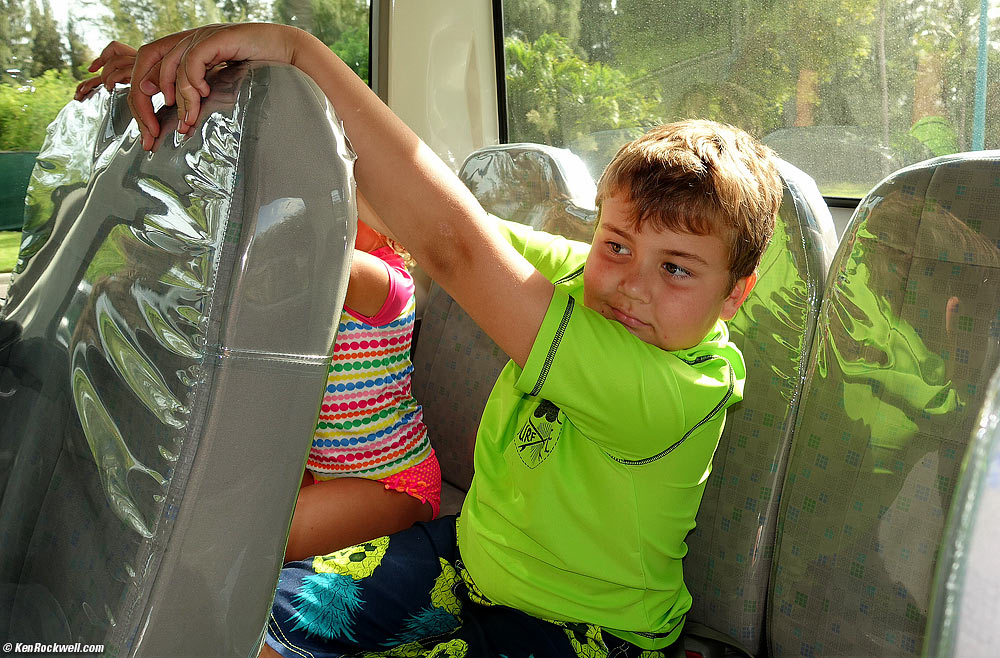 Kids playing in the back of the shuttle bus