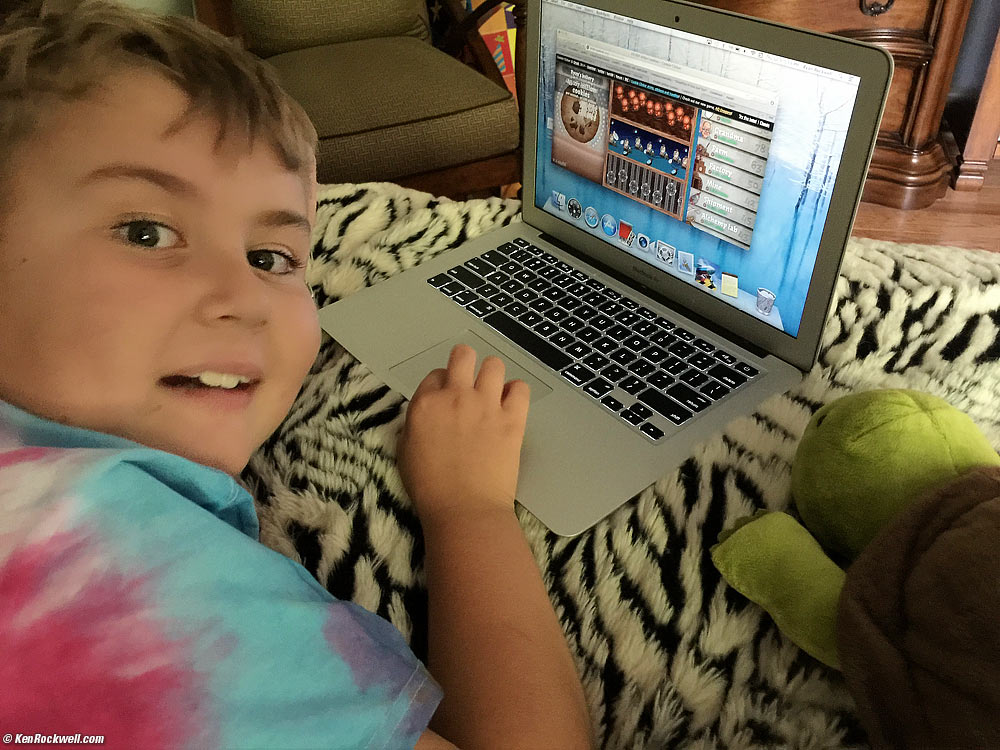 Ryan and Mr. Turtle play on his MacBook Air.