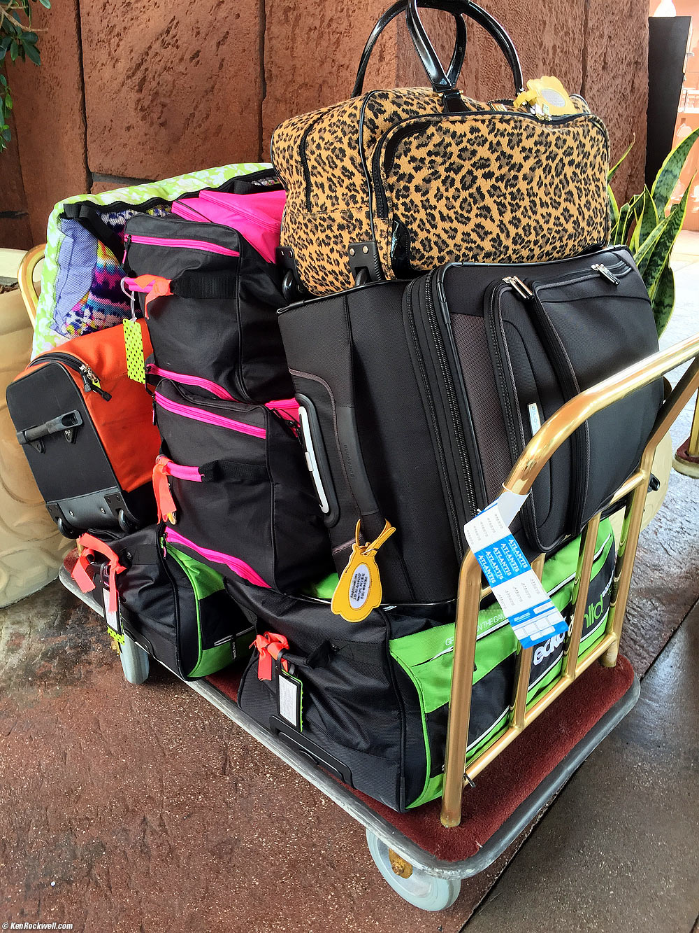Huge pile of luggage on bellman's cart