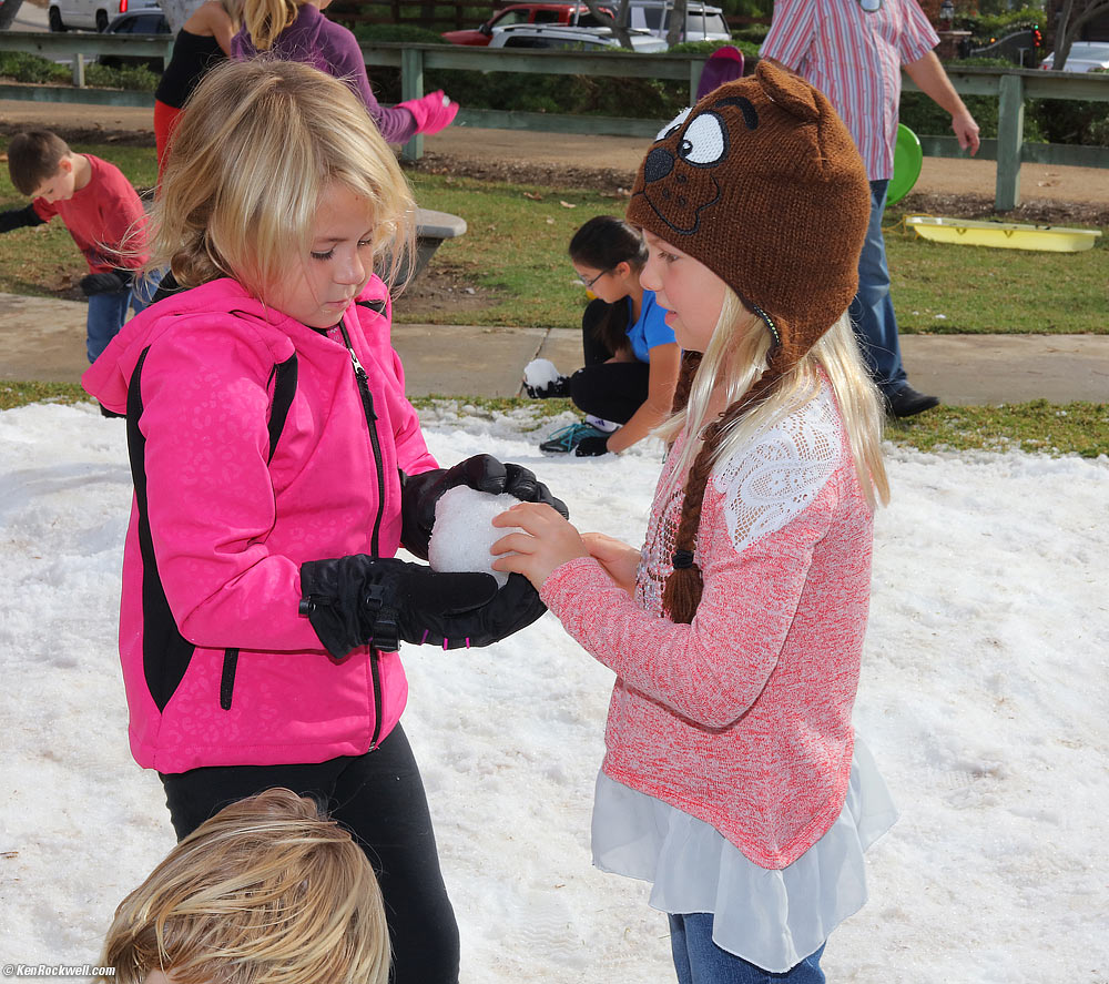 Katie passes a snowball to Caroline