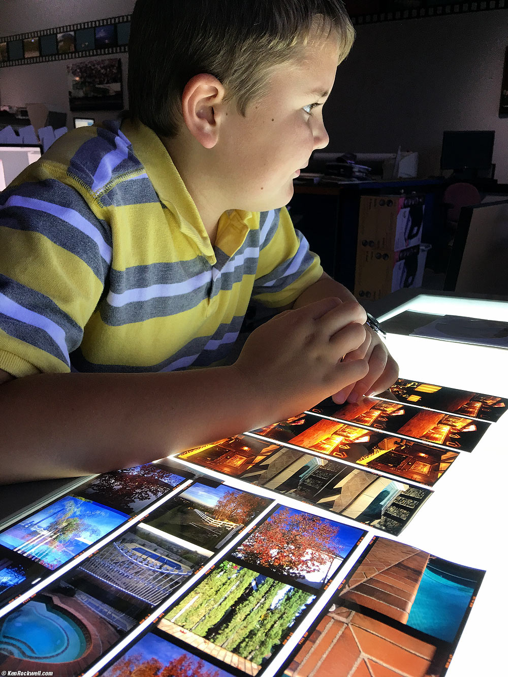 Ryan checks out dad's' chromes at the photo lab.