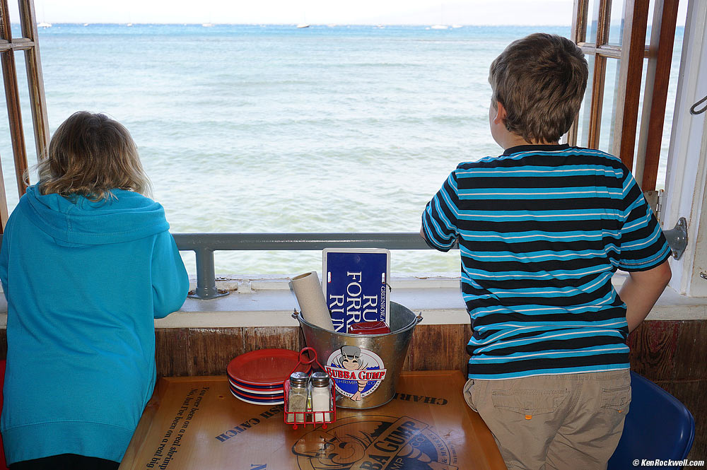 Katie and Ryan look out an open window towards the sea, Lahaina