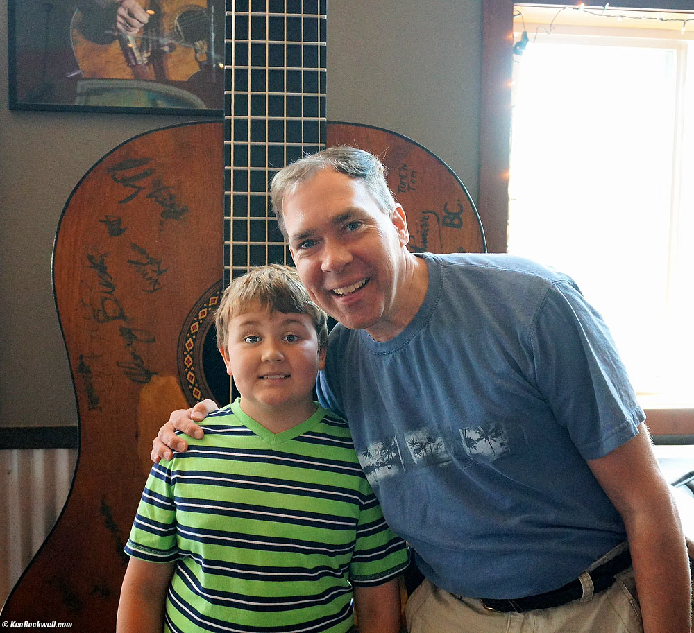 Ryan and Dad by the giant Willie Nelson guitar at Charley's Restaurant and Saloon, Paia, Maui