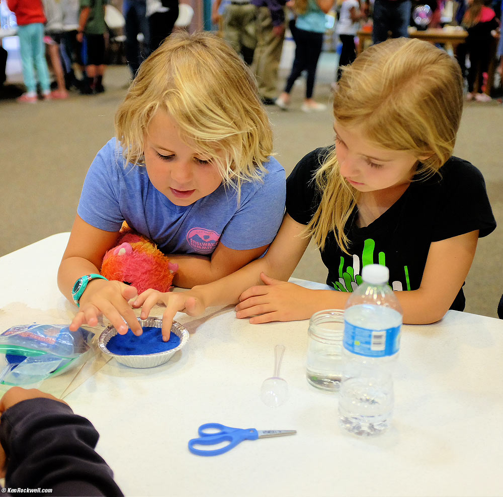 Katie and best friend Alyssa playing with blue sand
