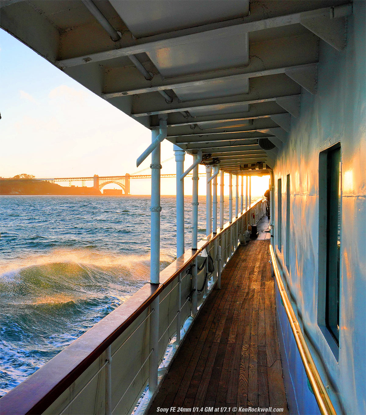 Sunset over the Golden Gate Bridge as seen from the San Francisco Bay with waves from the USS Potomac