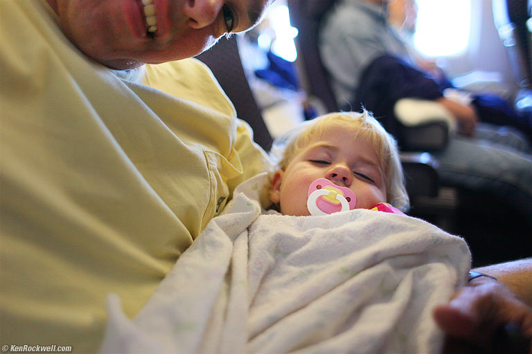Katie asleep in dad's arms, 5:35 PM HST (8:35 PDT).