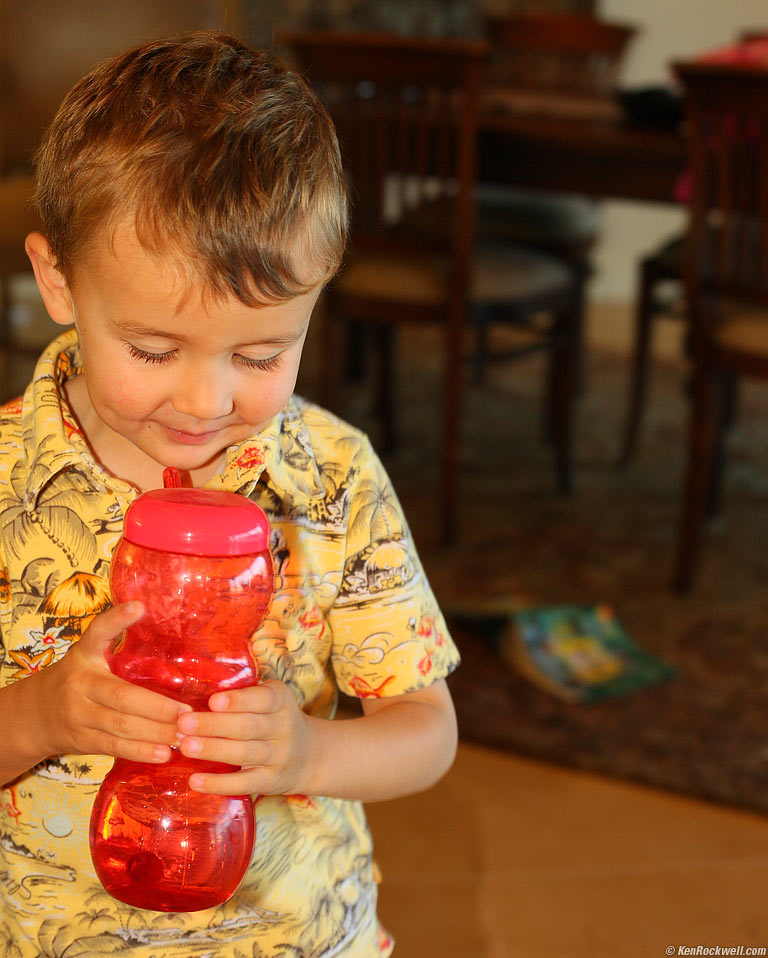 Blowing looking at his bubbles in the silly straw cup, Wailea, Maui. 8:12 AM.