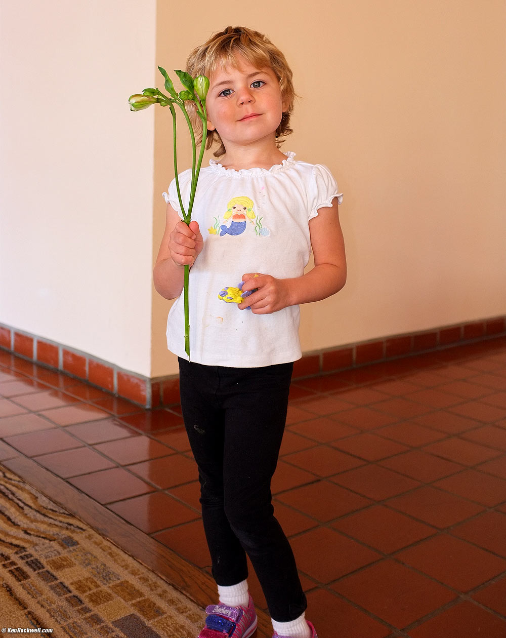 Katie scored a free flower fro the florist who was setting up the big arrangement in the lobby, 3:30 PM.
